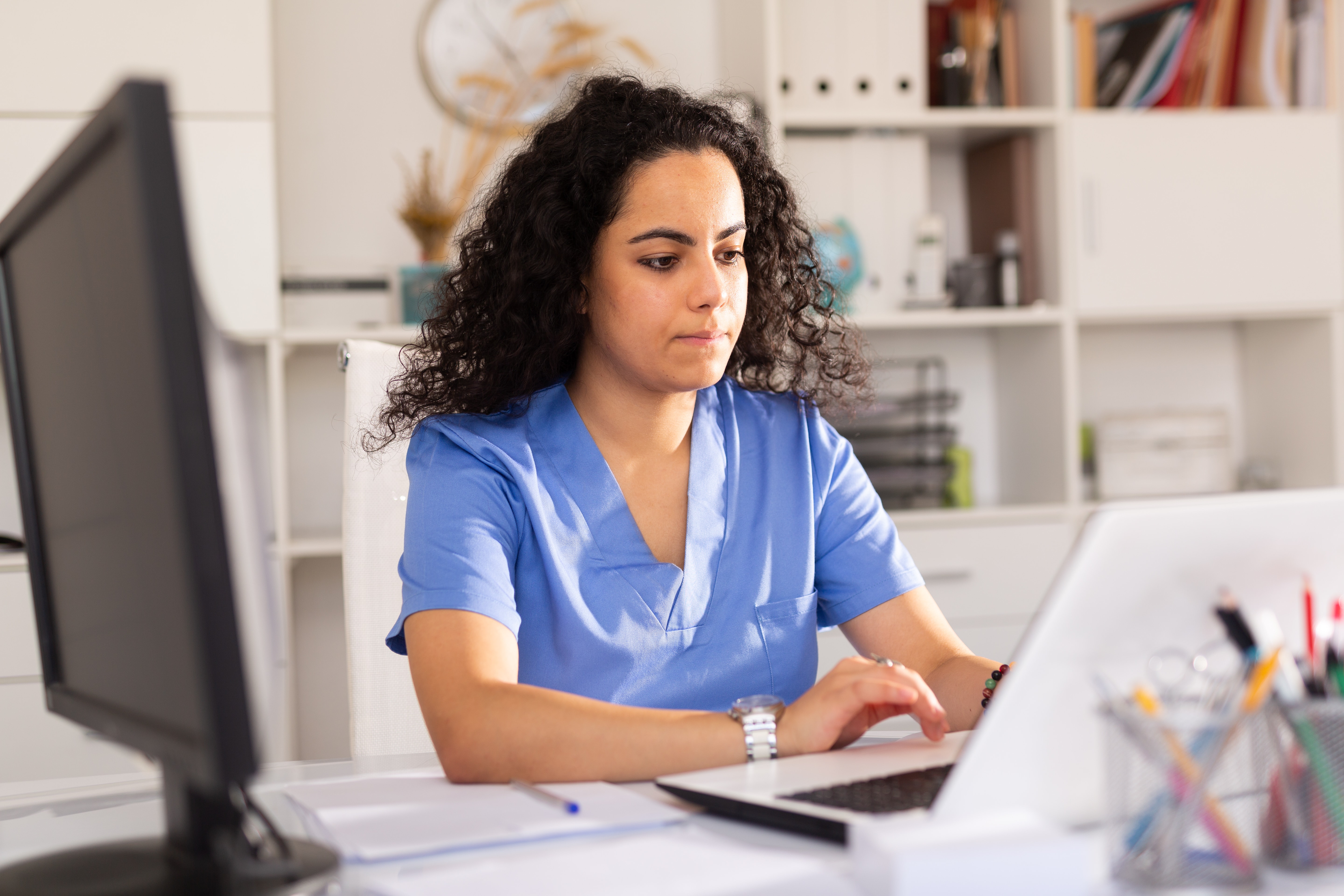 doctor reviewing patient chart on electronic health record system