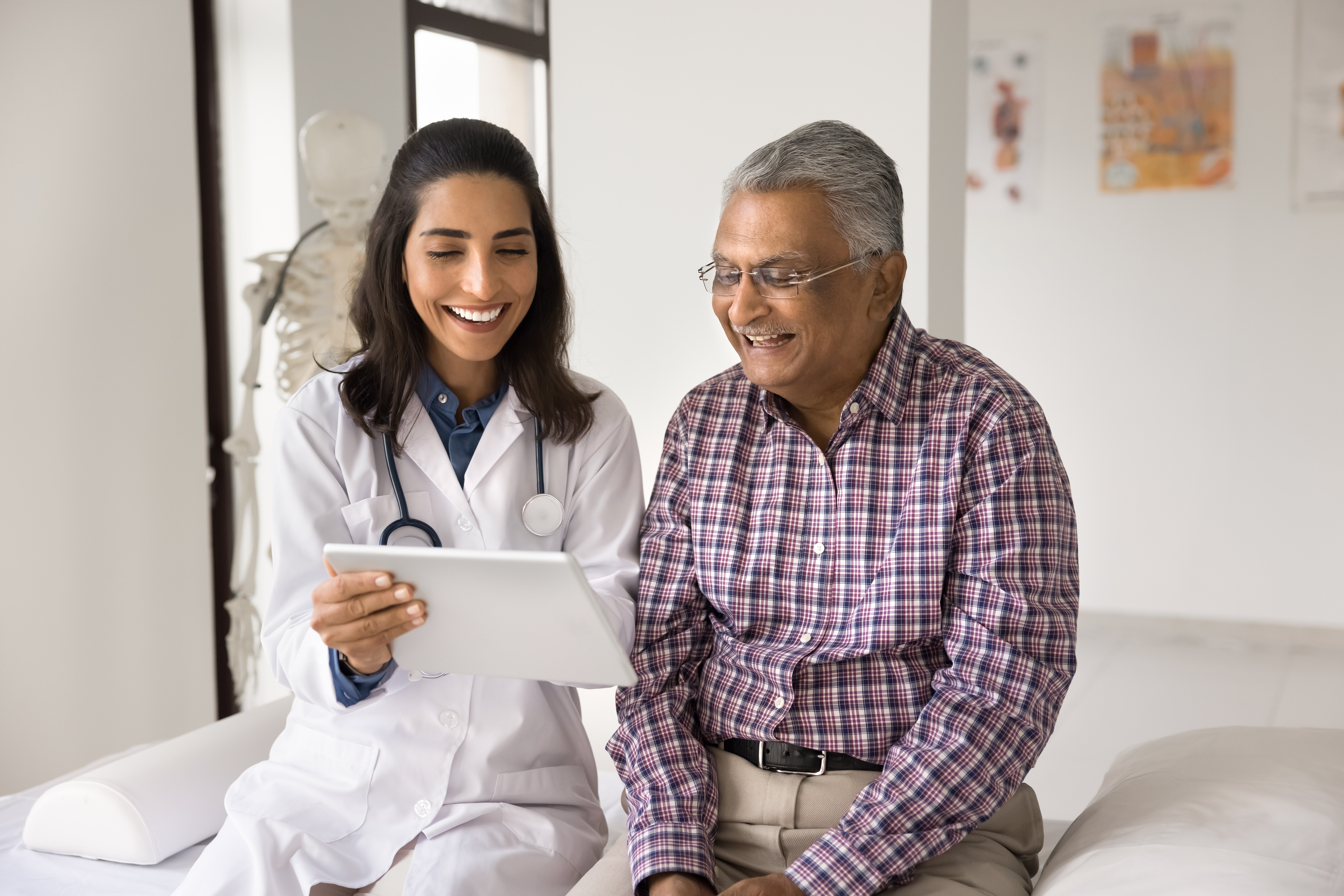 doctor comparing imaging results in electronic health record